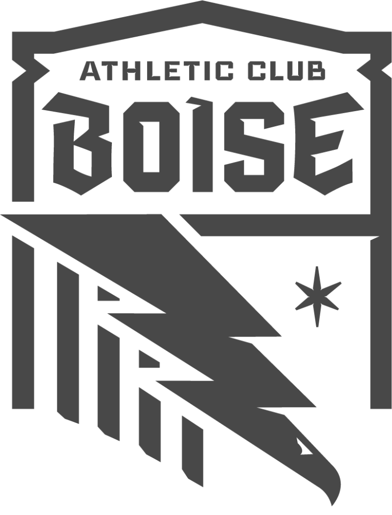 Design breakdown of the 'Treasure Valley' element in the Athletic Club Boise crest. The image shows a faded crest on the left with the bold 'V'-shaped bottom segment highlighted, alongside descriptive text explaining how the shape represents the convergence of the Boise and Snake River valleys—symbolizing unity, place, and community at the heart of the club's identity.