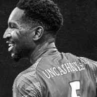 Black and white headshot image of Benian Yao playing in a soccer match