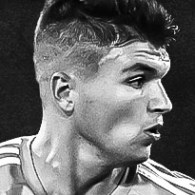 Black and white headshot of Denys Kostyshyn playing in a match