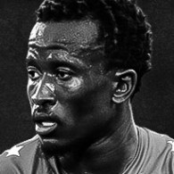 black and white headshot of Tumi Moshobane playing soccer